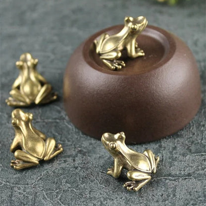 1. Three solid copper vintage frog figurines hand-carved for decor or collectibles.  