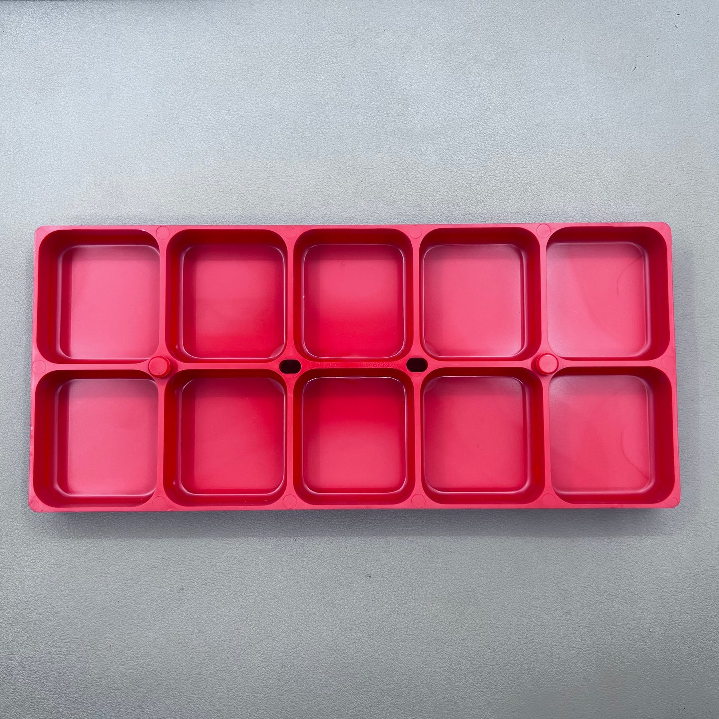 Swiss Horotec red plastic container with 10 compartments for organized watch accessory storage