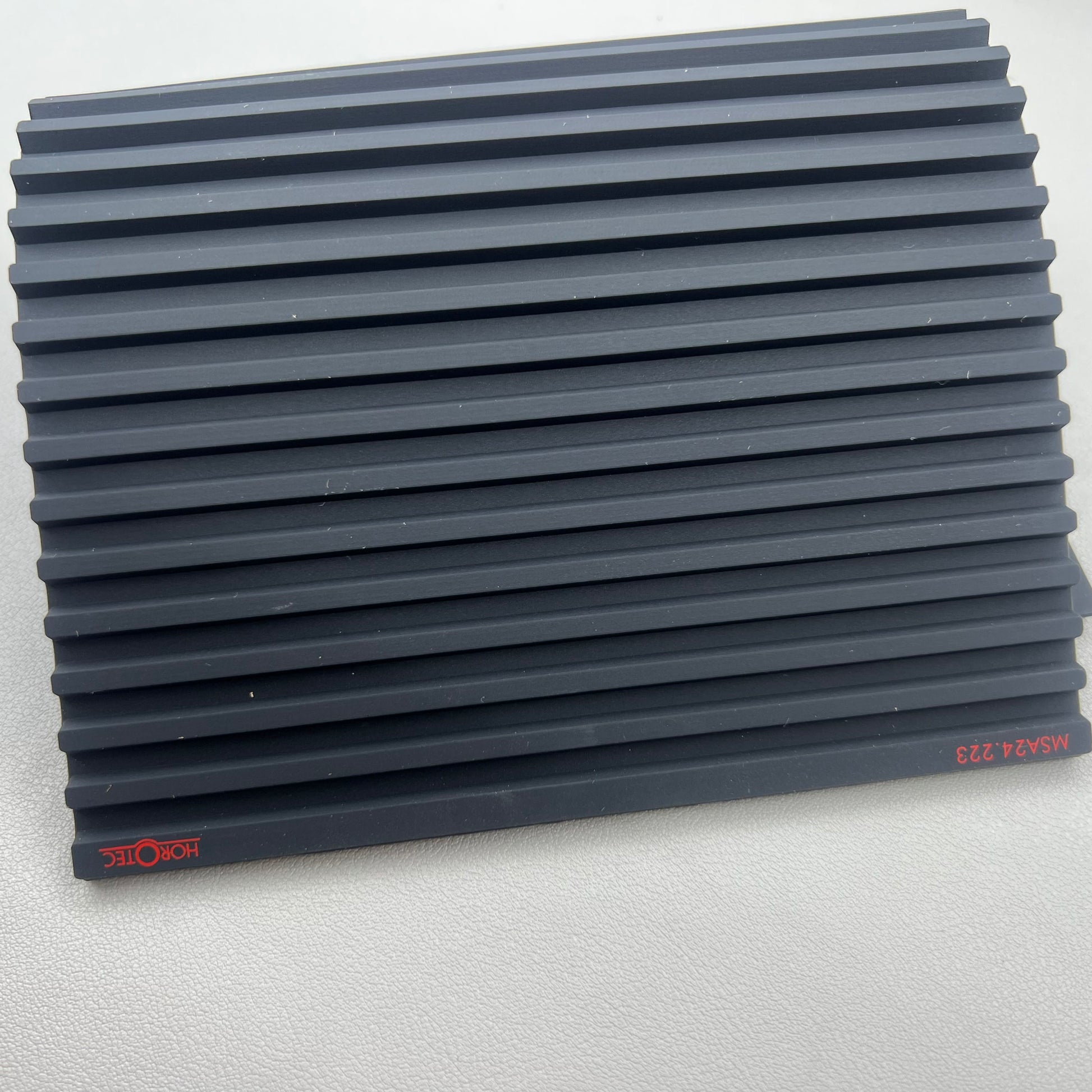 Swiss Horotec black silicon anti-slip bench mat with 32 grooves, ideal for watch repair tools organization.