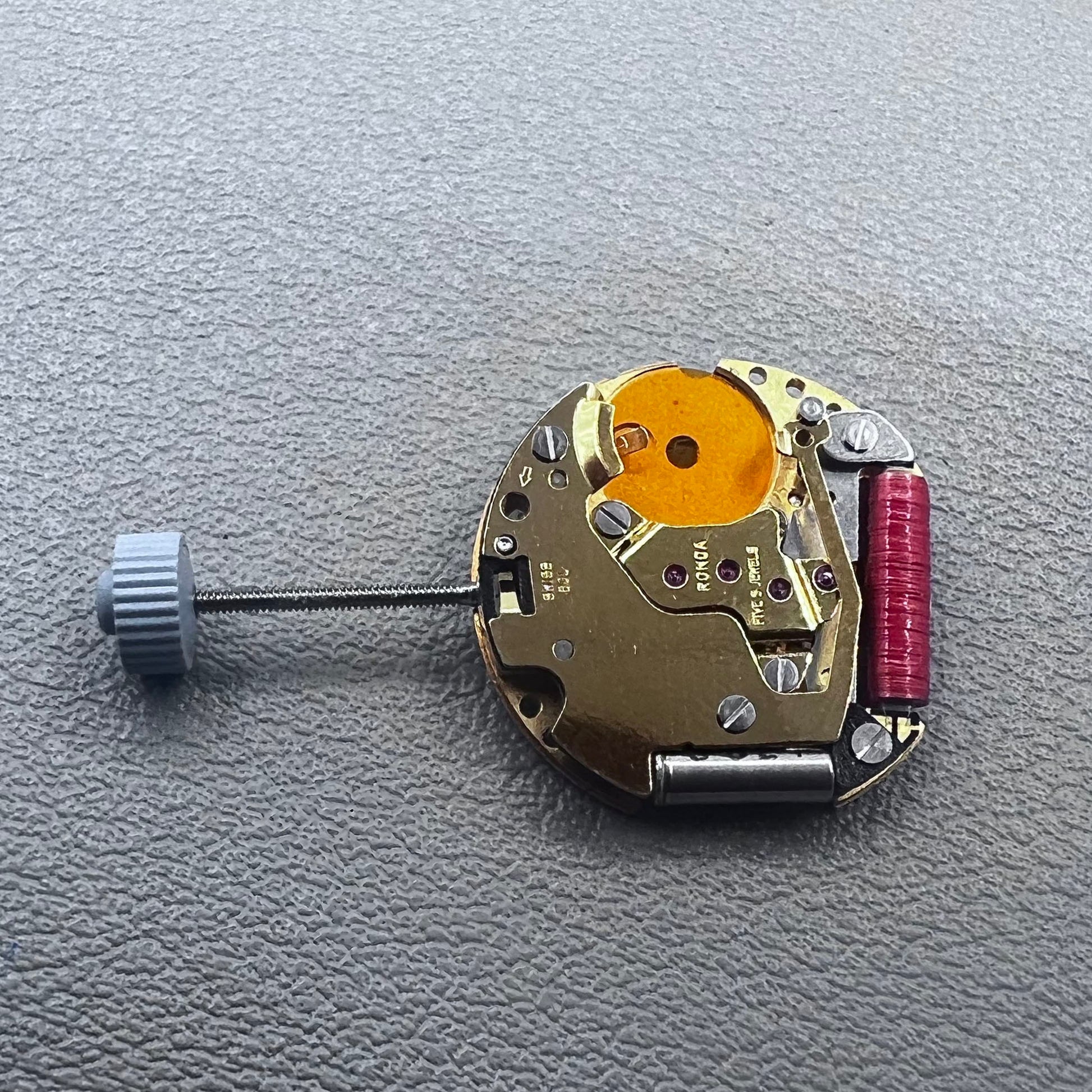 Swiss Ronda 775 quartz watch part with white date disk at 6 o'clock, ideal for precise repairs.