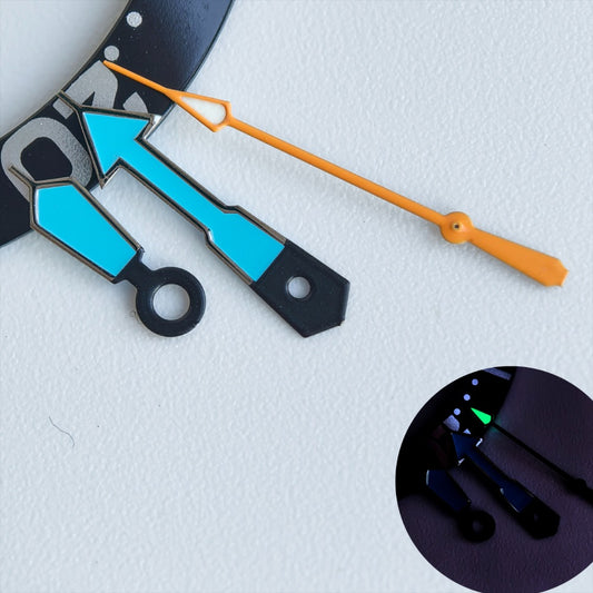 Dark silver trim watch hands with blue and orange accents, green lume for NH35/36 movements.