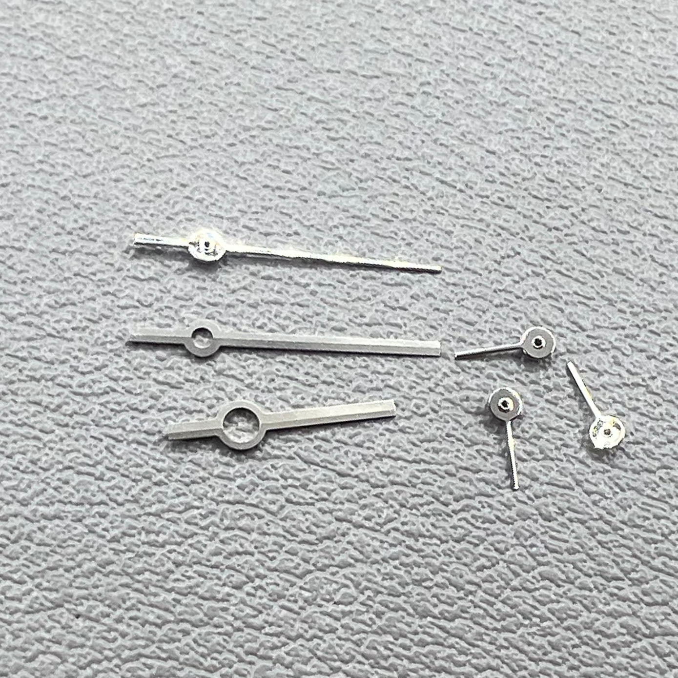 Silver watch hands set compatible with Ronda 5030.D quartz movement, precision timepiece parts.