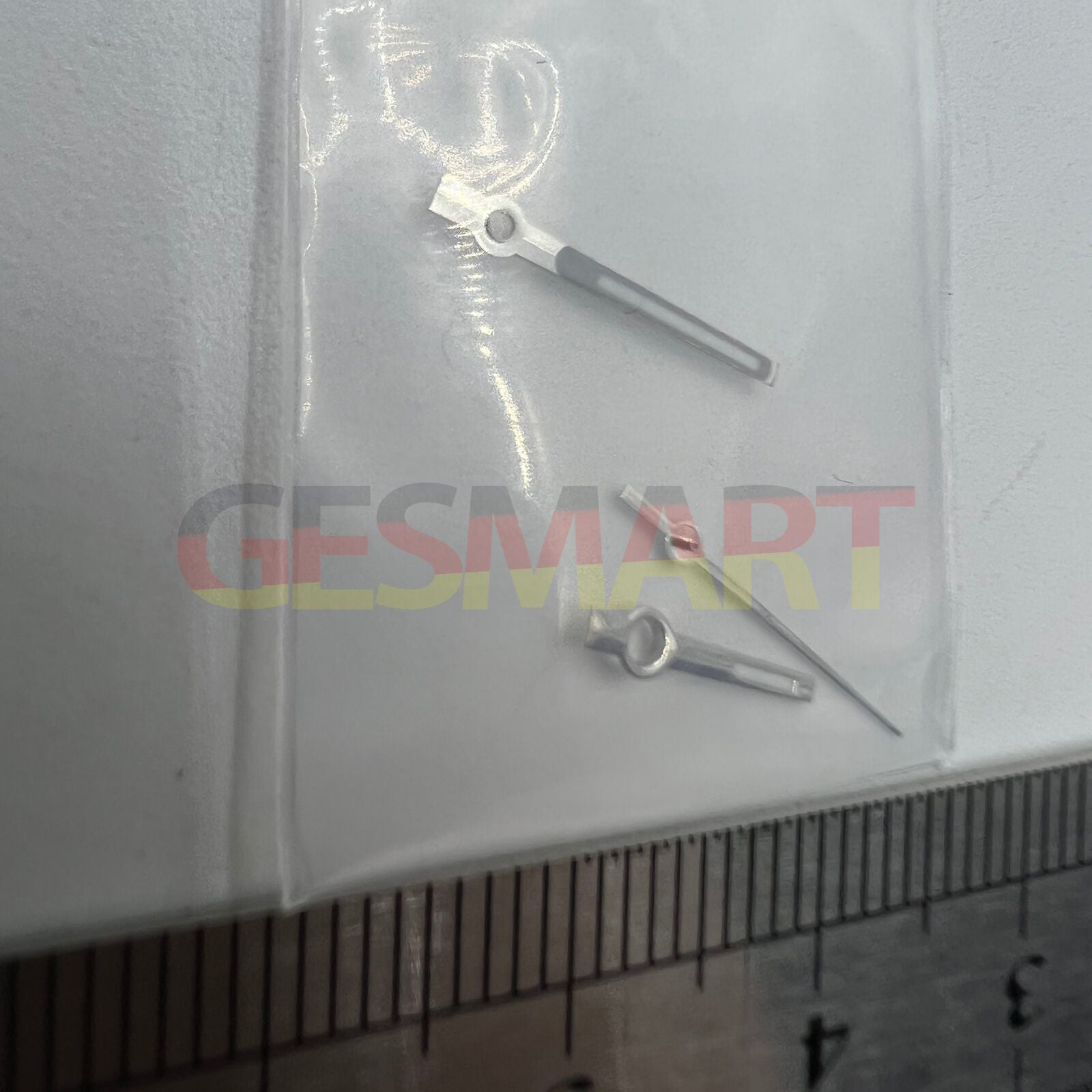 Silver-trimmed green luminous watch hands for NH35/NH36/4R/7S movements, glowing in low light.