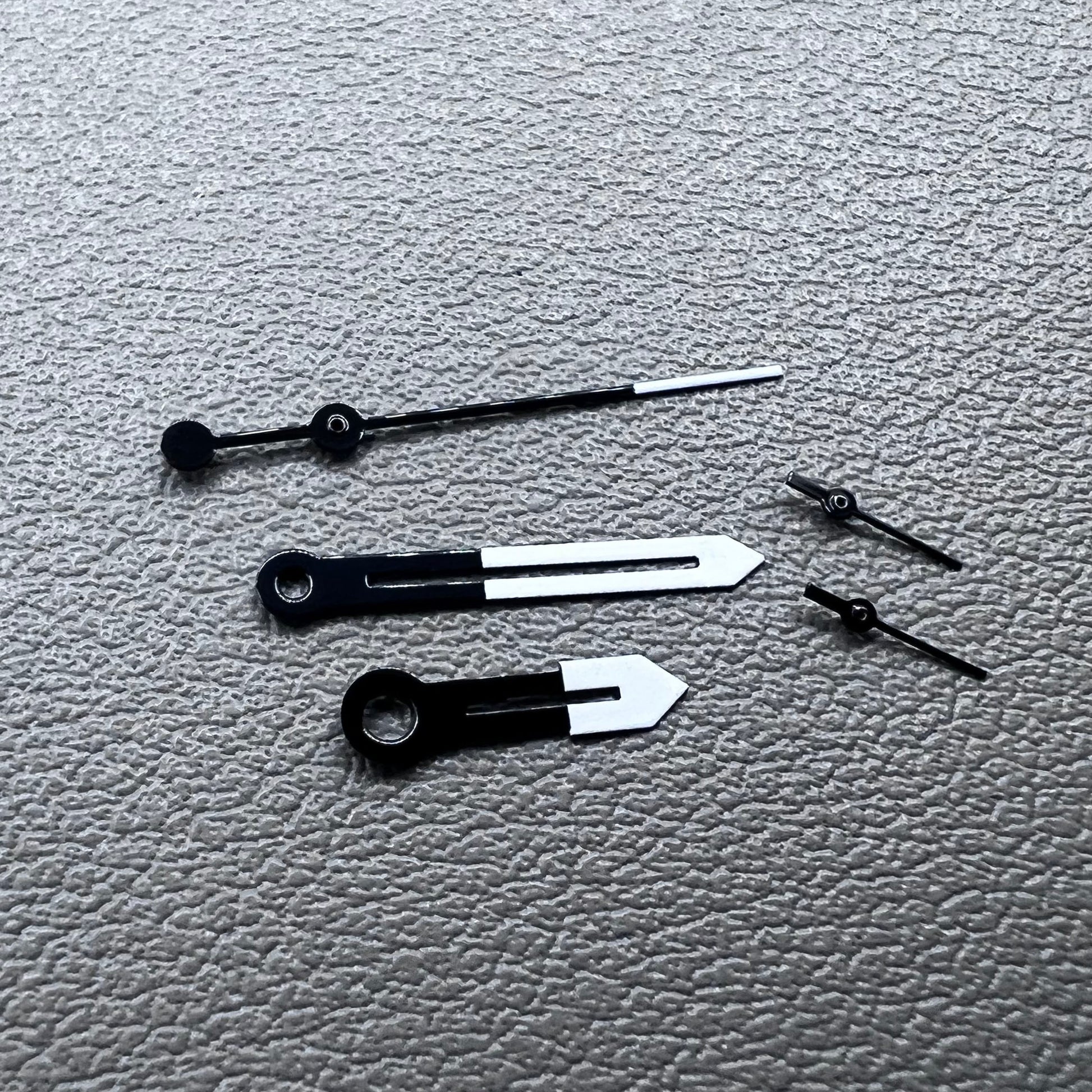 White and black watch hands designed for Ronda 5021D quartz movement.
