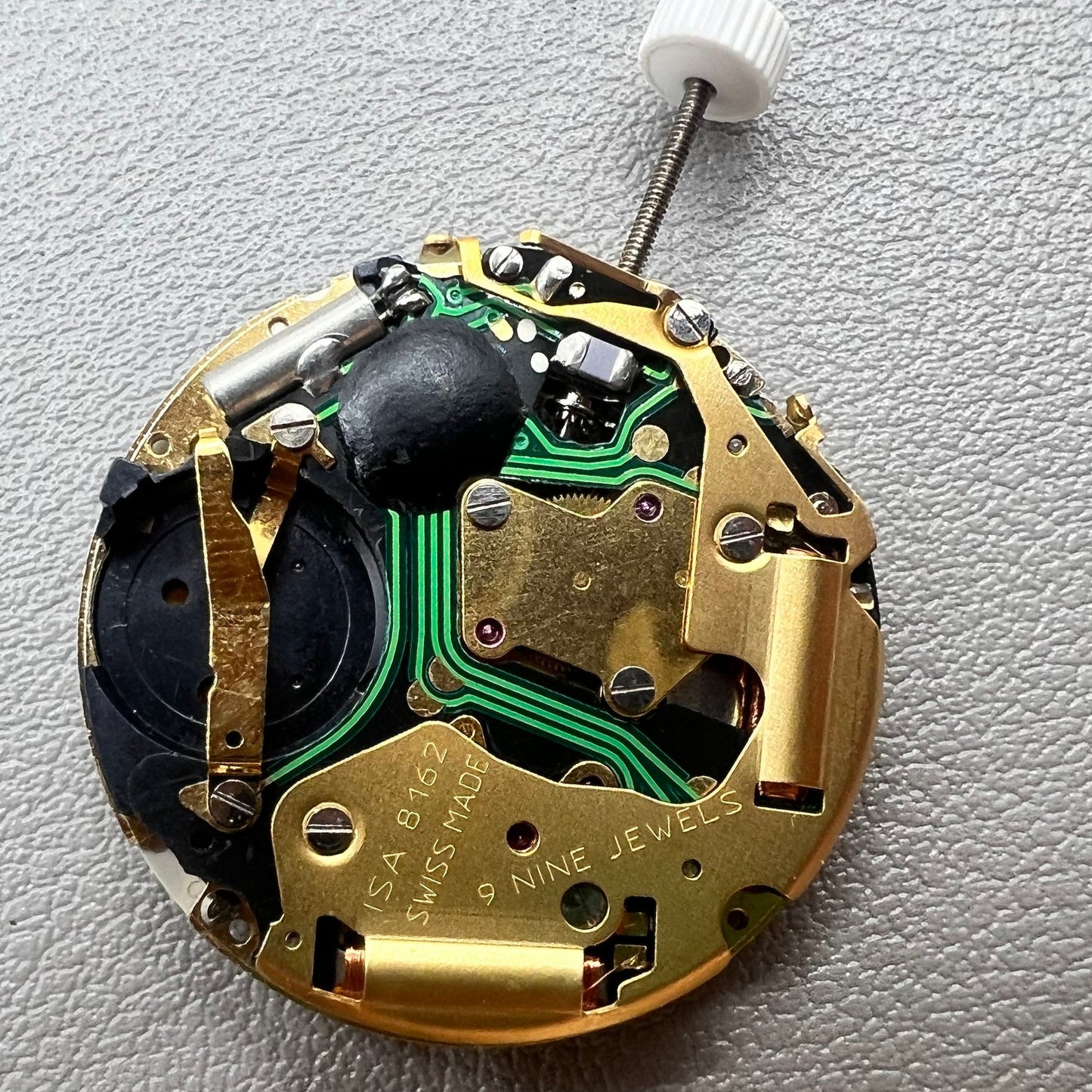 Swiss ISA 8162 golden watch disk with date feature, quartz movement replacement by ISA, ideal for watch repair.