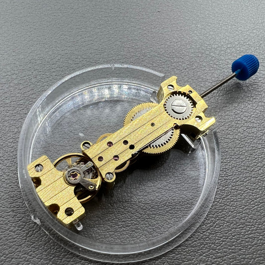Golden Long Hand winding watch movement showcasing intricate mechanical craftsmanship.