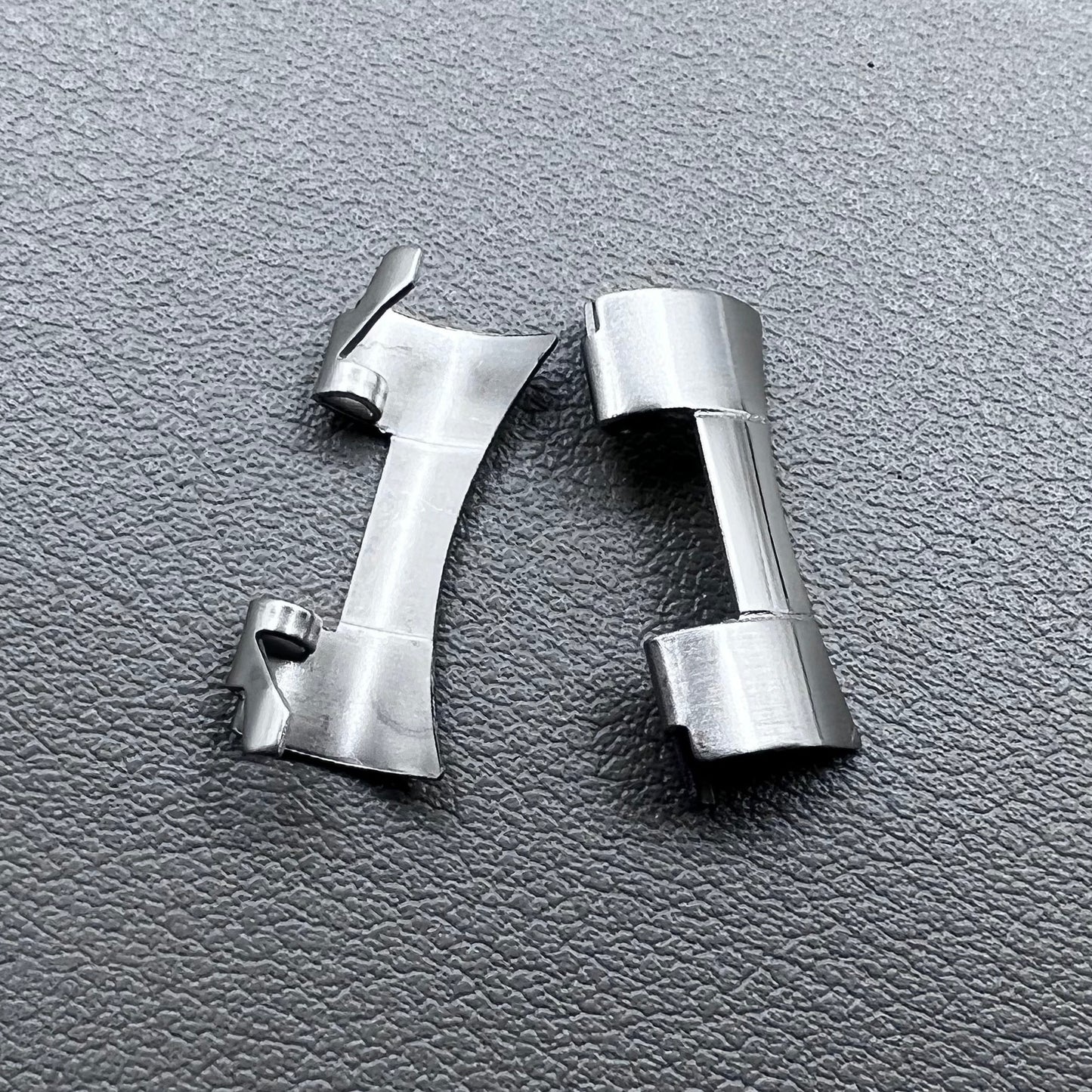 Set of 2 stainless steel 20x9mm curved end links and spring bars for watch bands, compatible with various straps.