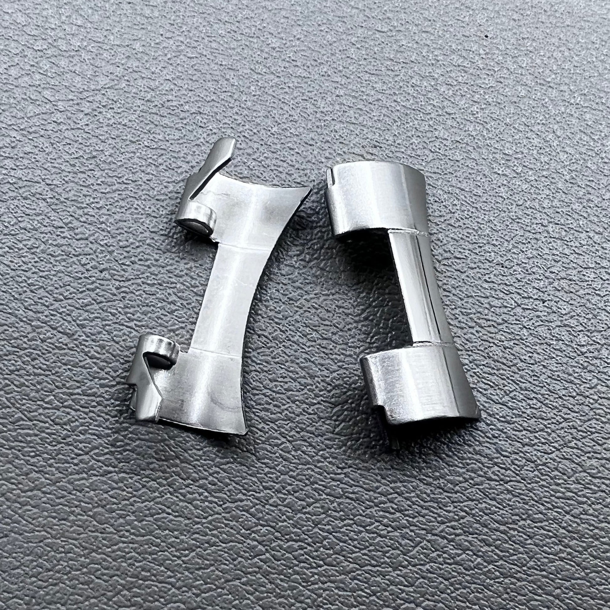 Set of 2 stainless steel 20x9mm curved end links and spring bars for watch bands, compatible with various straps.