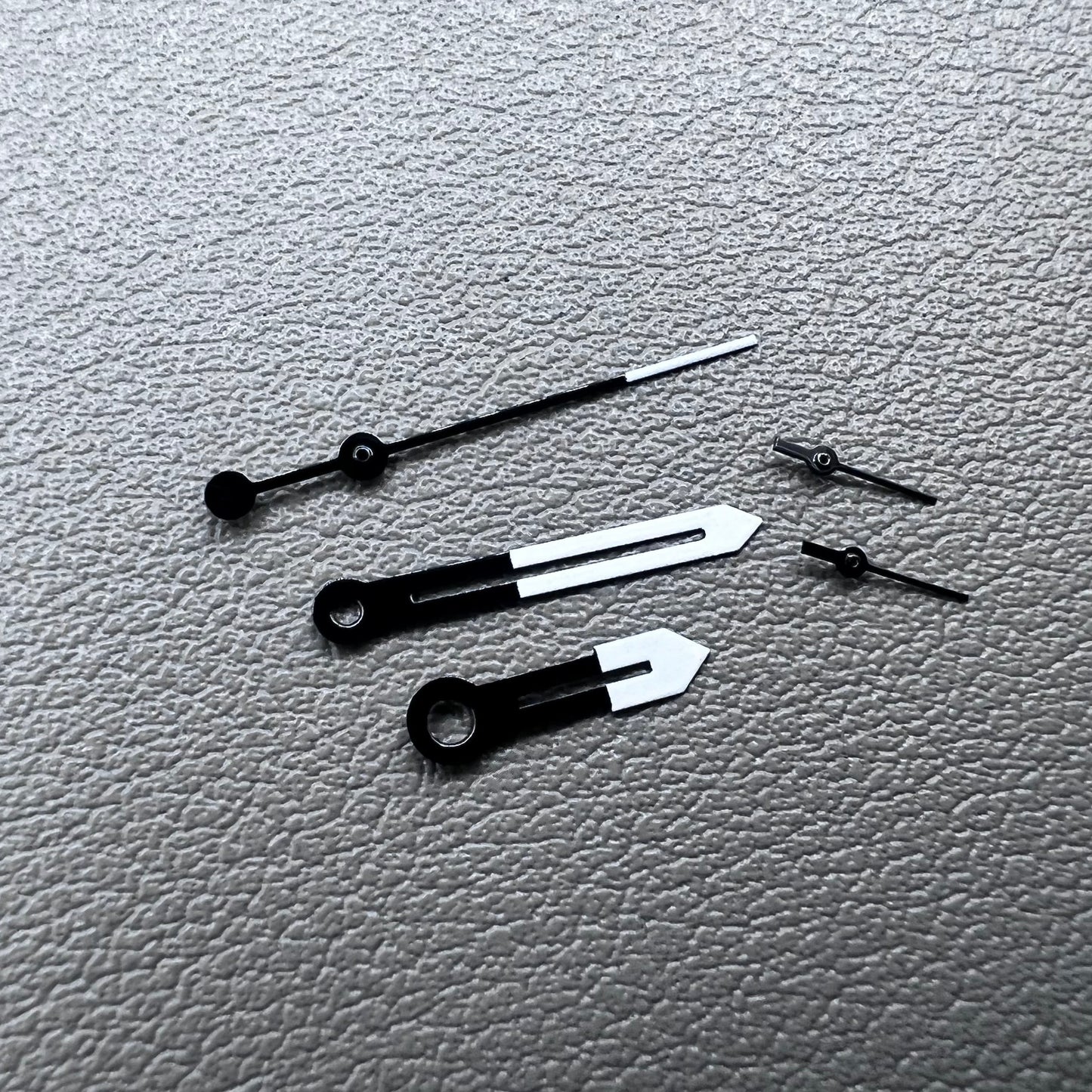 White and black watch hands designed for Ronda 5021D quartz movement.