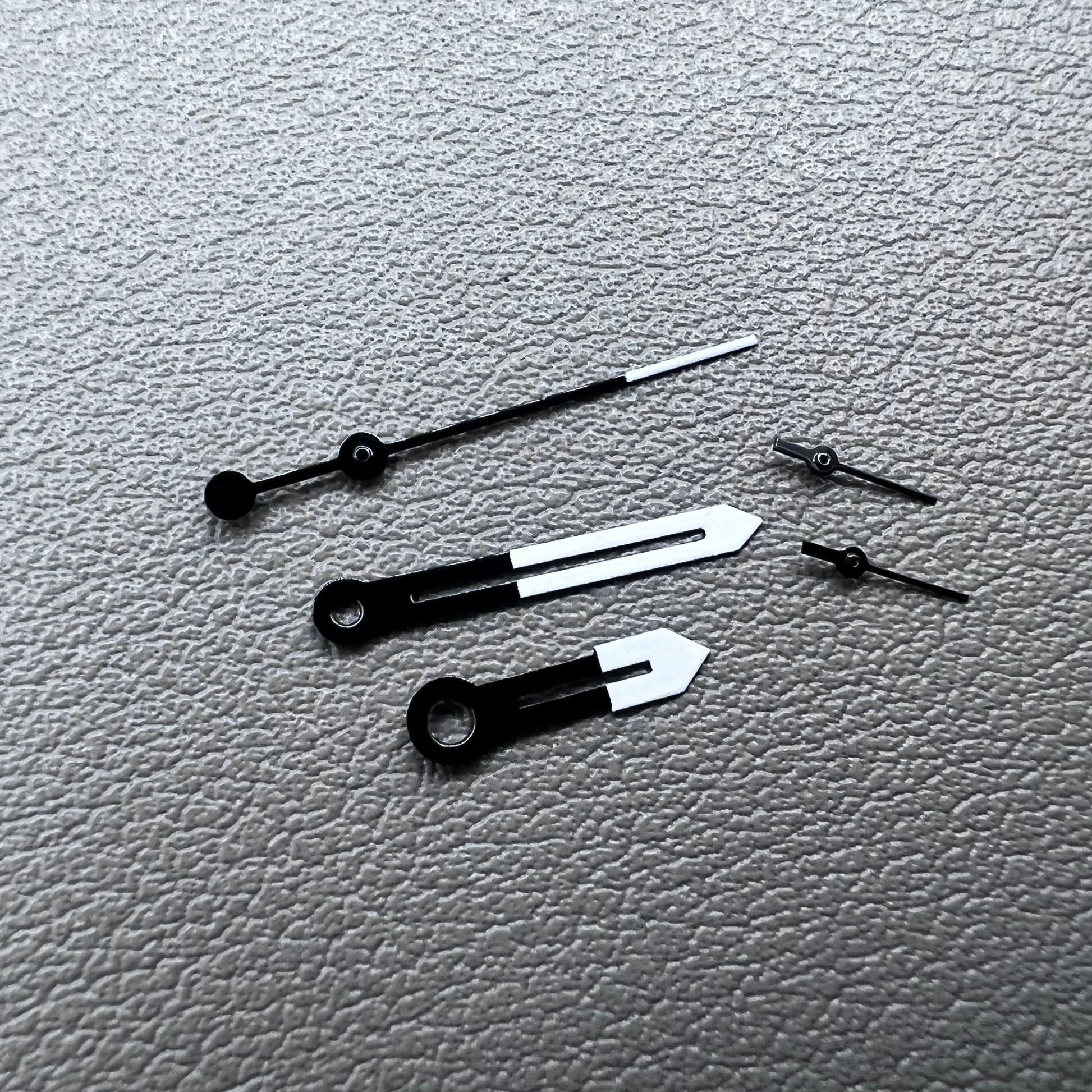 White and black watch hands designed for Ronda 5021D quartz movement.