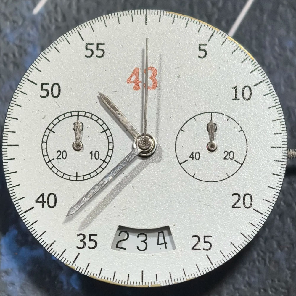 Dandong 7750 mechanical watch movement showing date at 3 o'clock and small second at 9 o'clock.