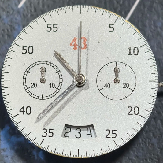 Dandong 7750 mechanical watch movement showing date at 3 o'clock and small second at 9 o'clock.