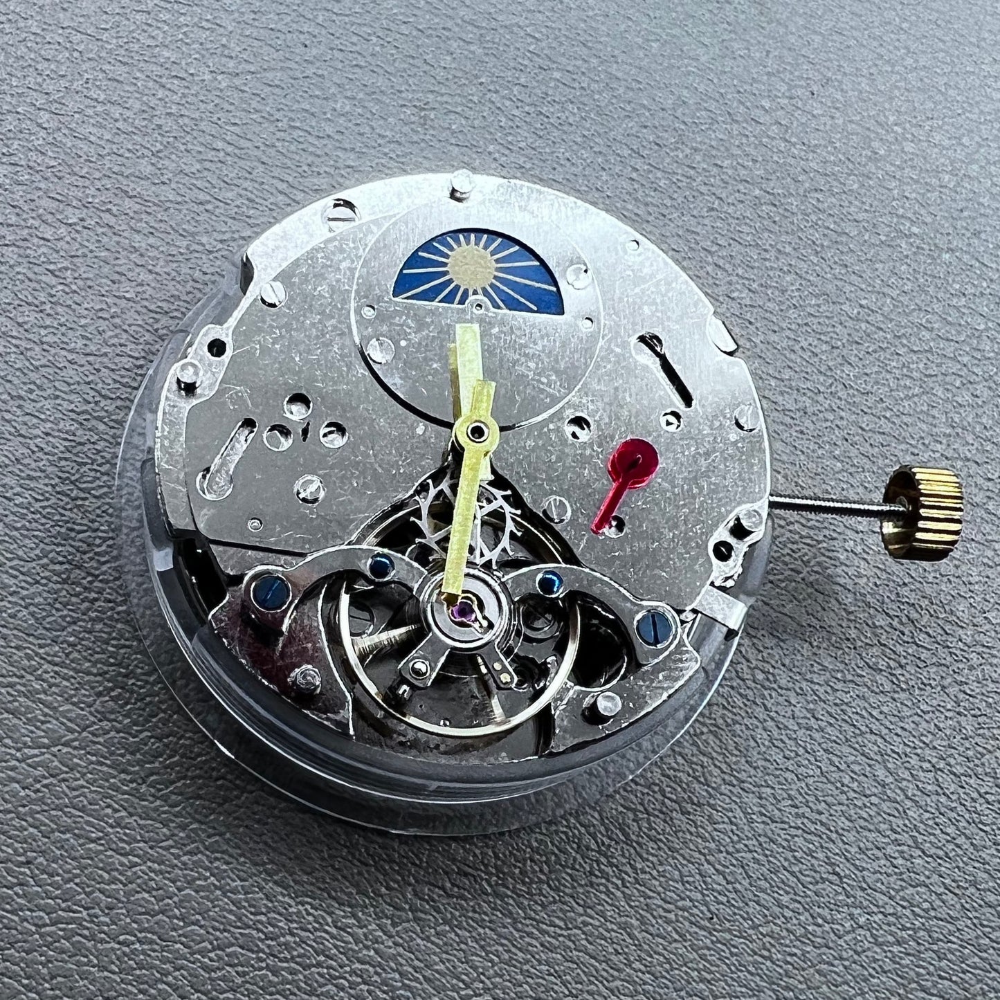 Silver Asian Dandong automatic watch with mechanical movement, date and week indicators, moon phase display.