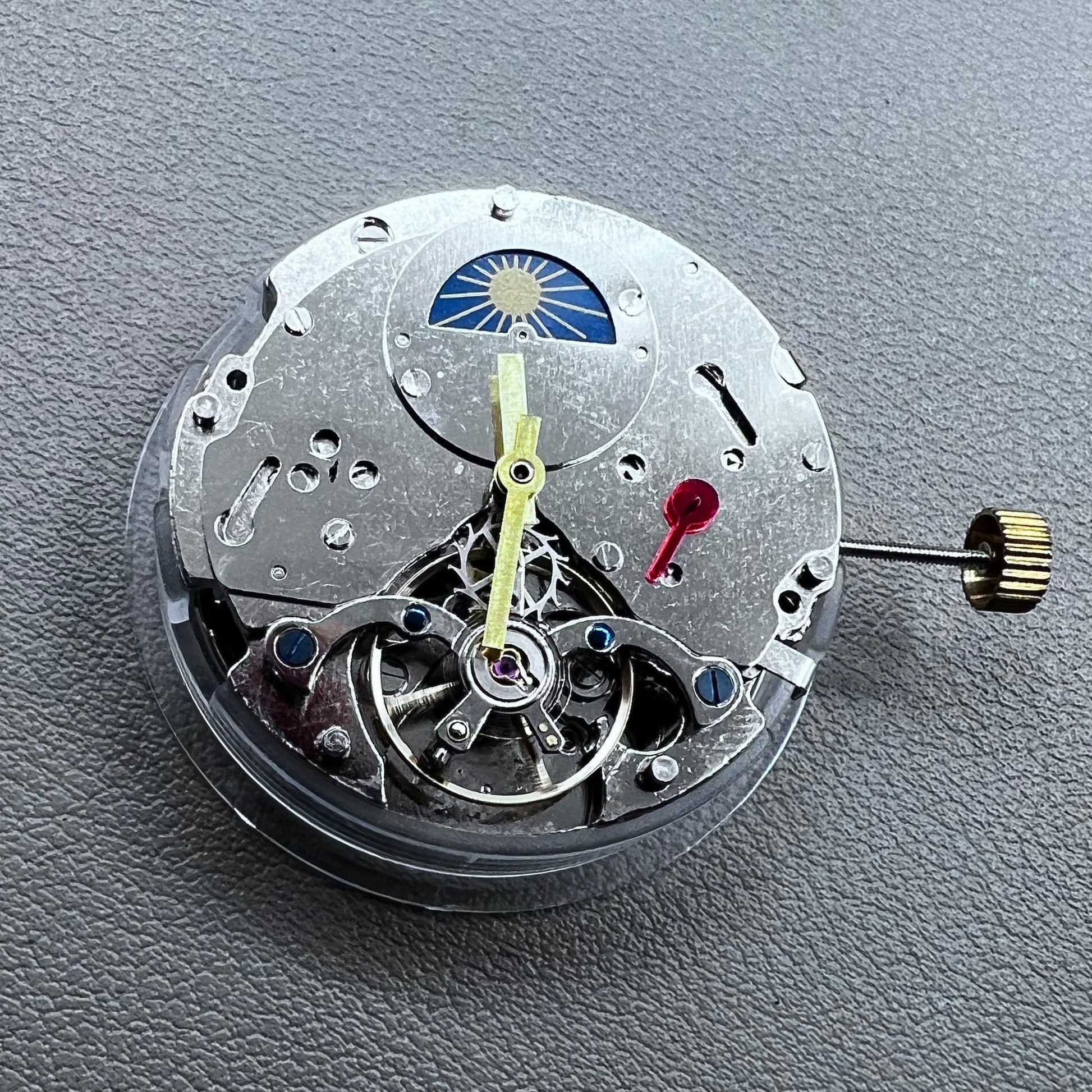 Silver Asian Dandong automatic watch with mechanical movement, date and week indicators, moon phase display.