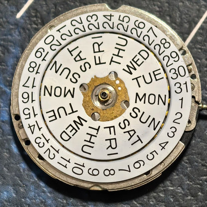 Swiss Made ISA 1198 quartz watch part with day-date display and three-hand movement for precise timekeeping.