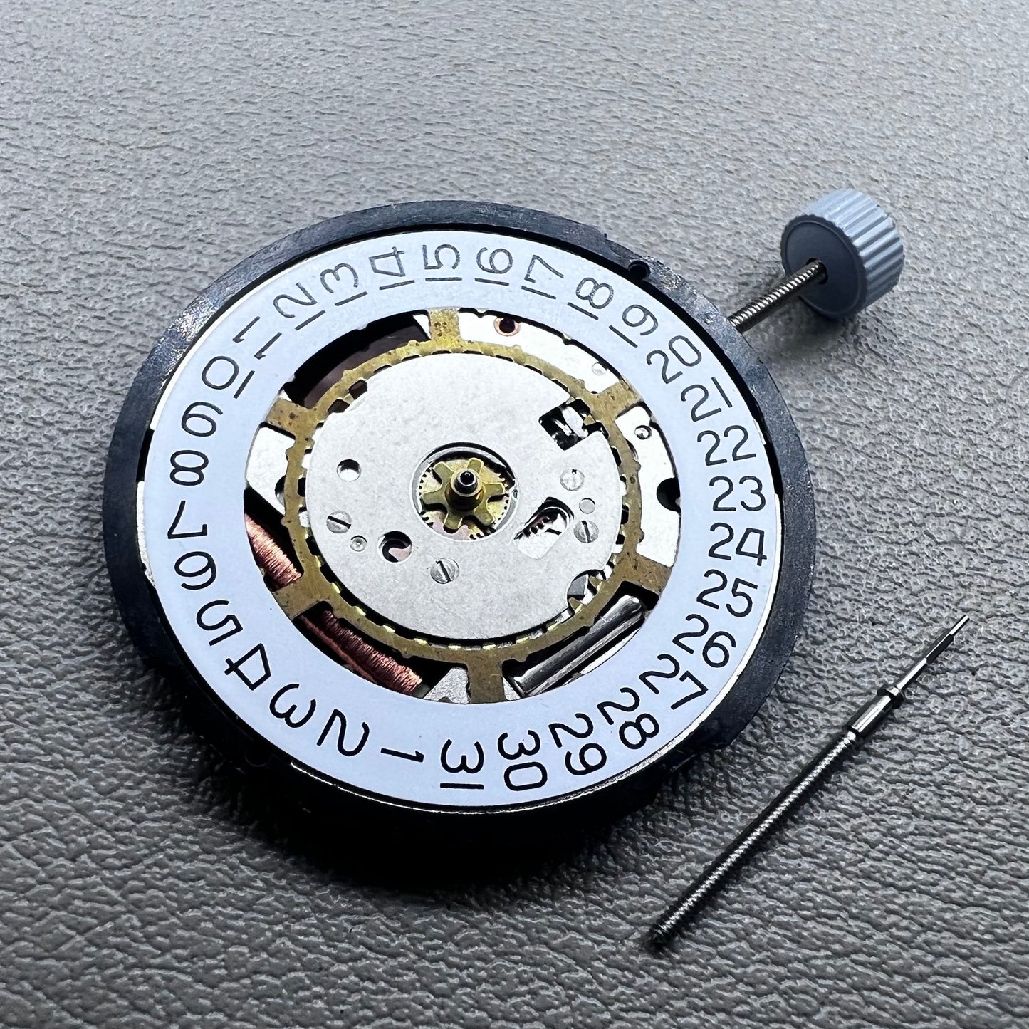 Swiss Ronda 715 quartz watch movement with date display at 3 o'clock, precision timing for accessories.