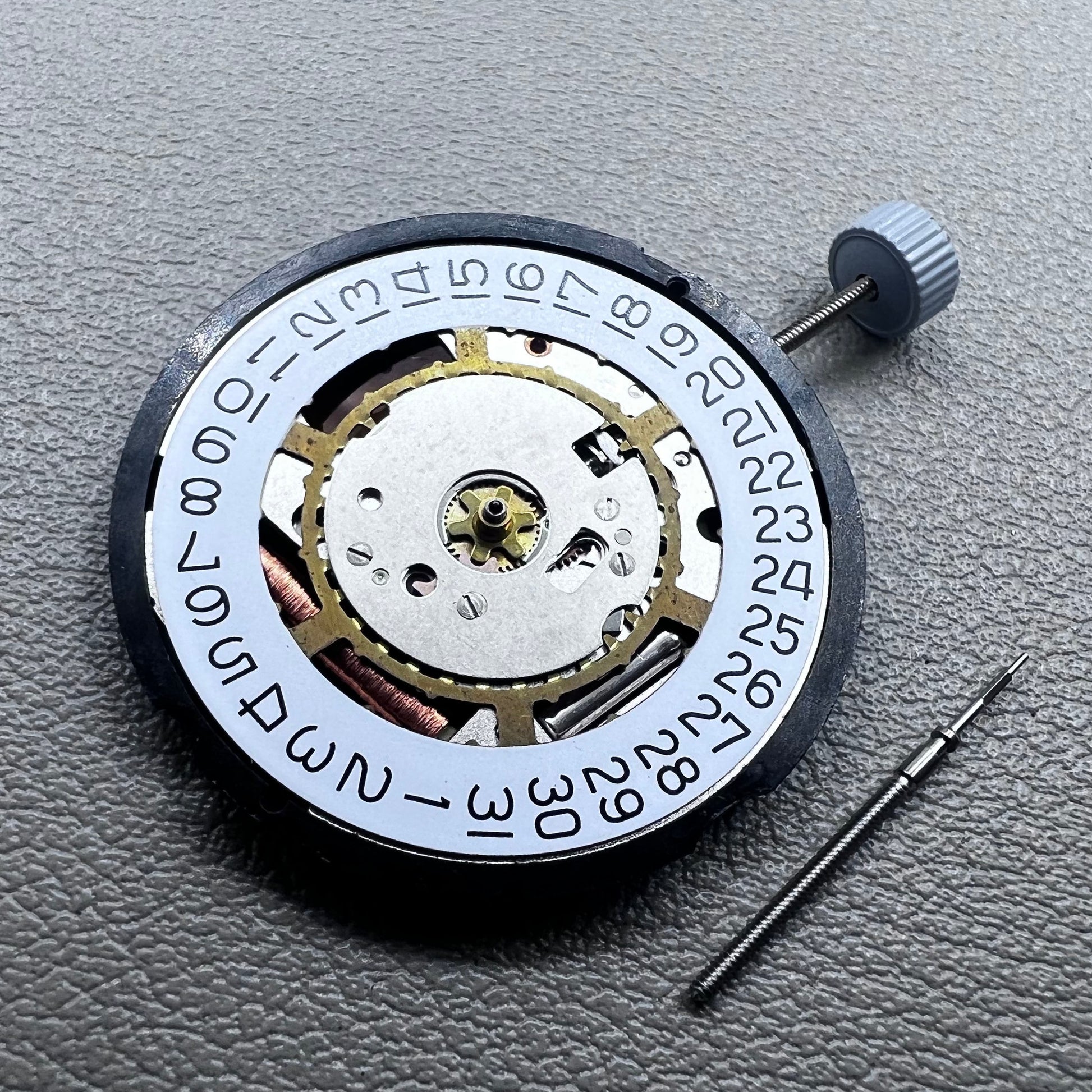 Swiss Ronda 715 quartz watch movement with date display at 3 o'clock, precision timing for accessories.