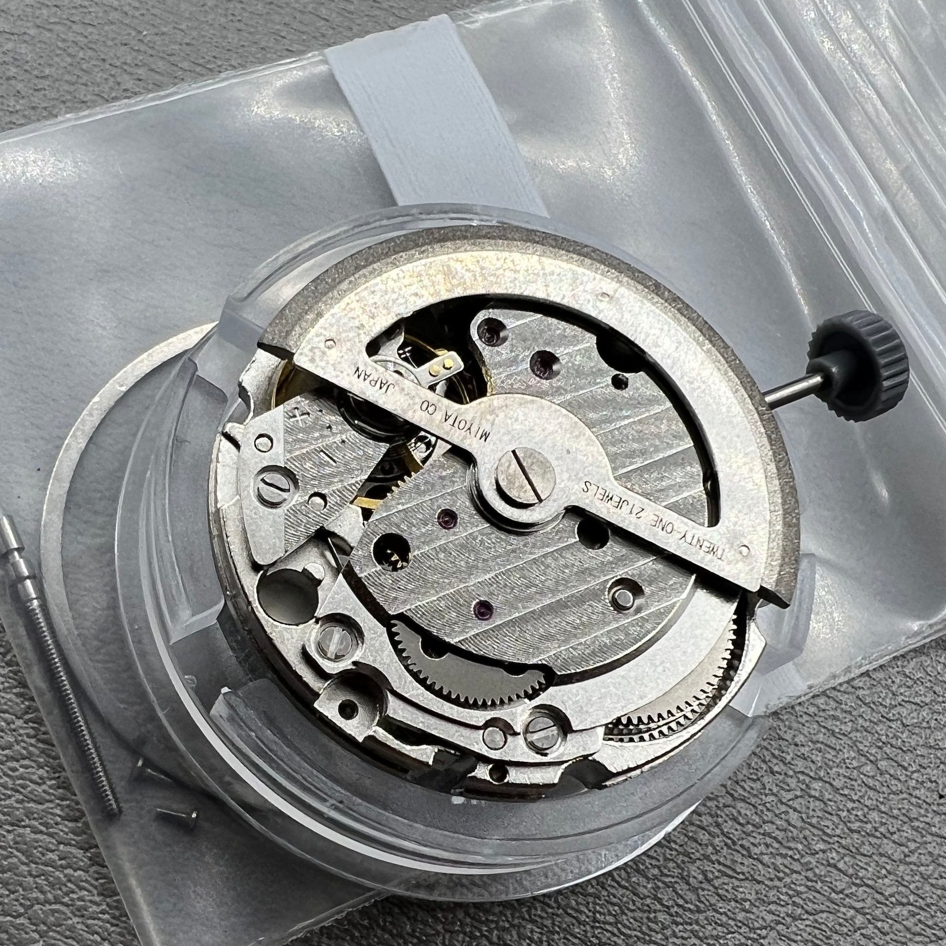 Japan Miyota 8218 automatic watch movement with date at 9 o'clock and two hands, precision timekeeping.