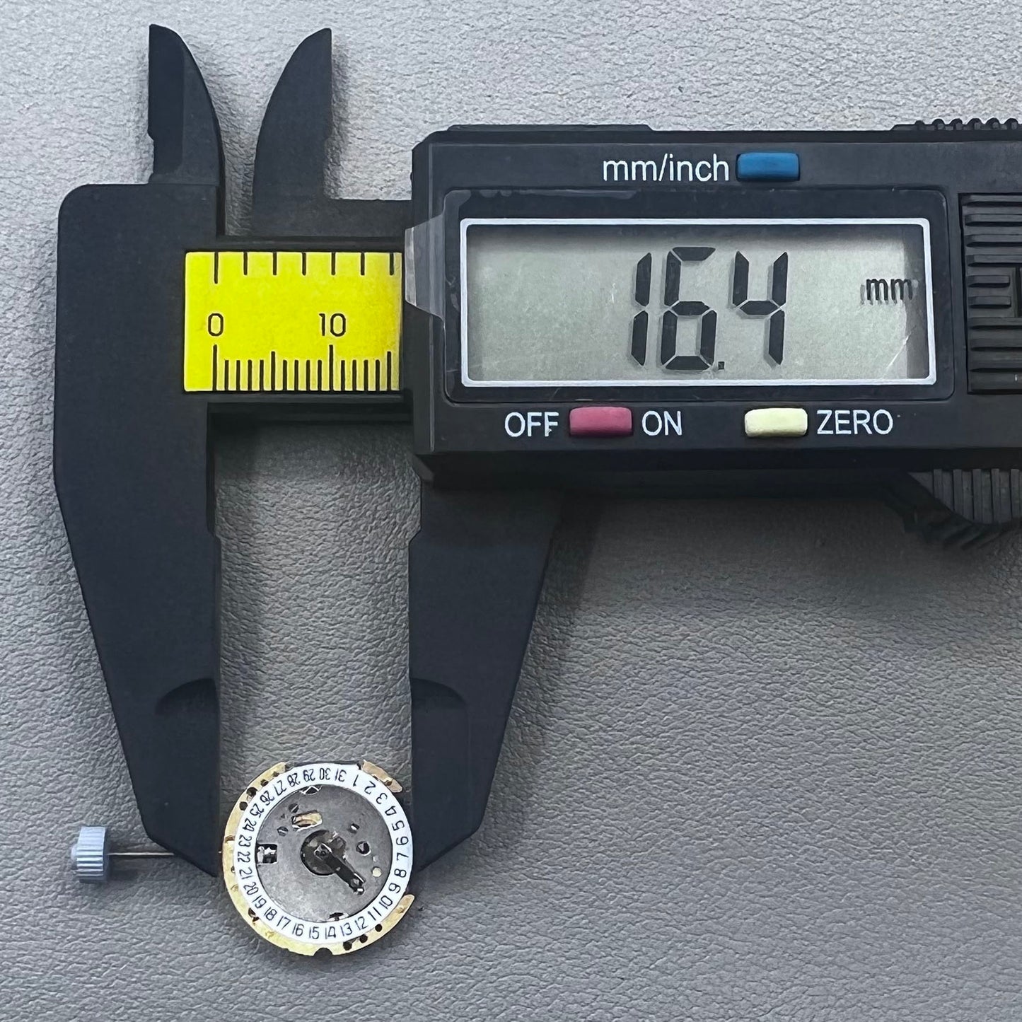 Swiss Ronda 775 quartz watch part with white date disk at 6 o'clock, ideal for precise repairs.