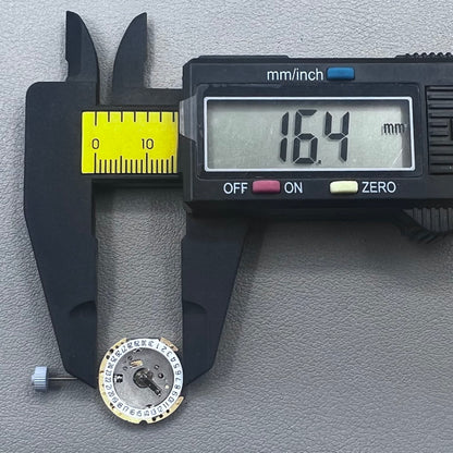Swiss Ronda 775 quartz watch part with white date disk at 6 o'clock, ideal for precise repairs.