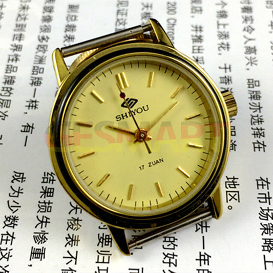34mm China made manual mechanical watch with 17 jewels, golden dial, and round golden case.