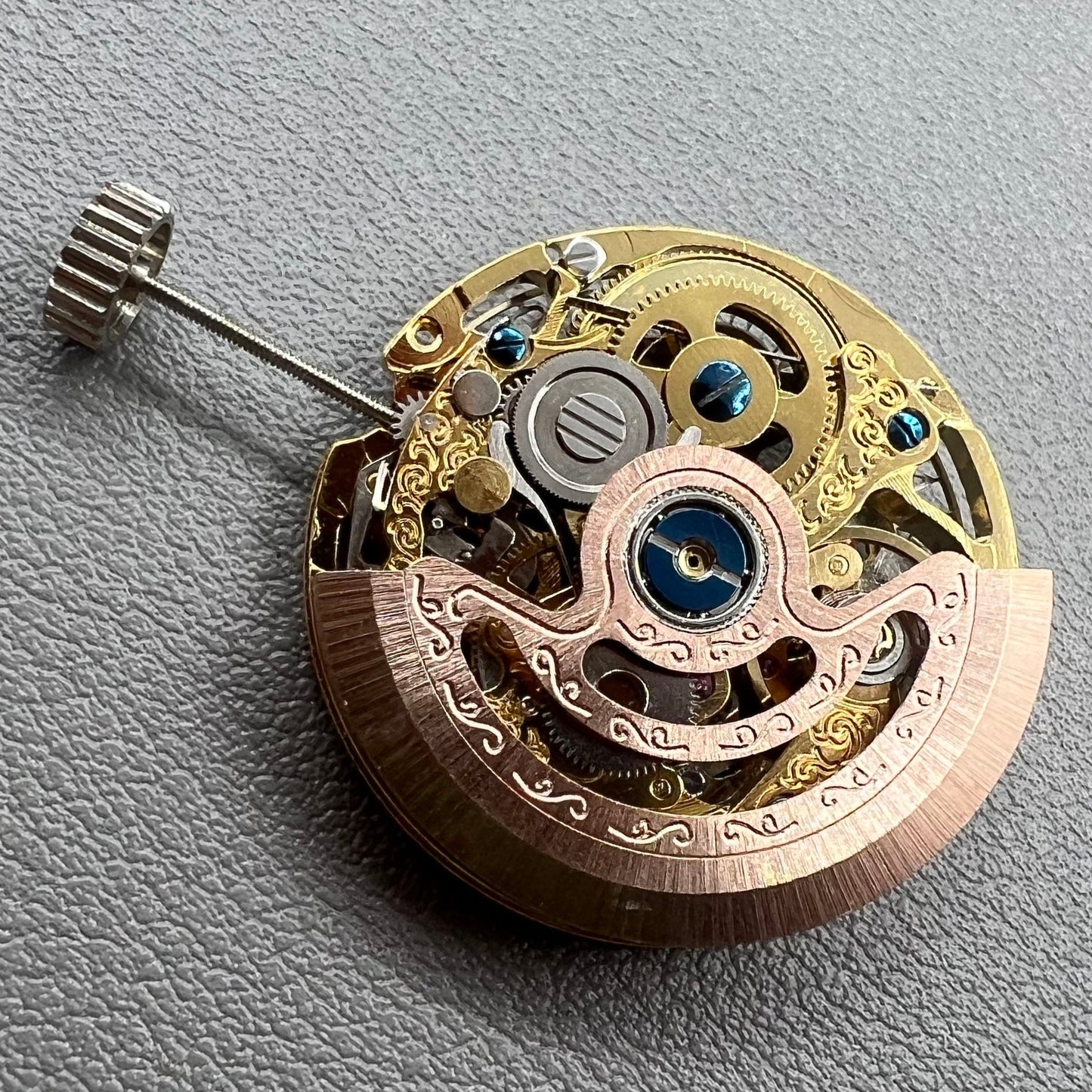Golden Hangzhou 2189 mechanical calendar watch movement showcasing intricate hollow design and precise craftsmanship.