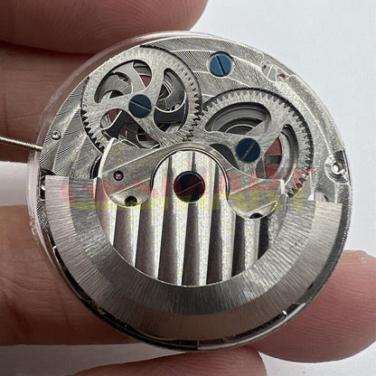 Double Mainspring dual time zone hollow mechanical watch movement with intricate gears and craftsmanship.