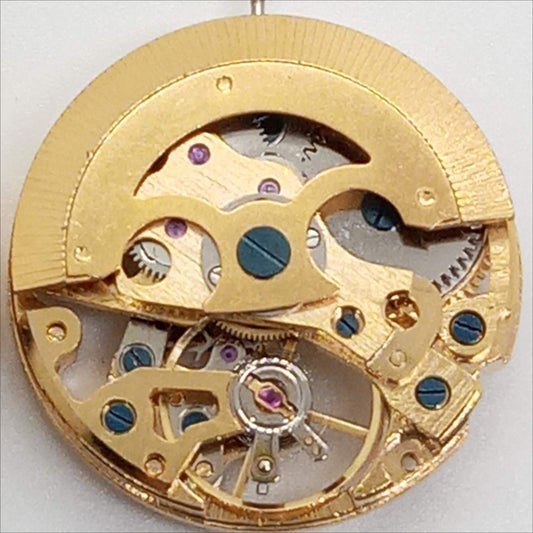 Dandong 7120 golden mechanical watch part with 3 hands and intricate hollow design.
