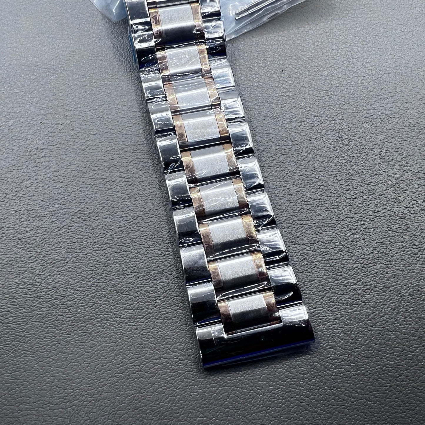Curved end 12-24mm steel watch band strap in rose gold and silver with butterfly clasp.