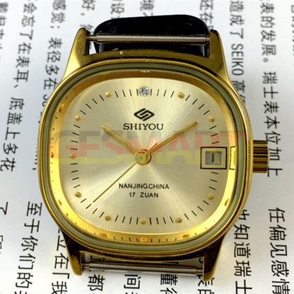 Golden 35mm manual mechanical watch with single calendar and elegant golden dial and case.