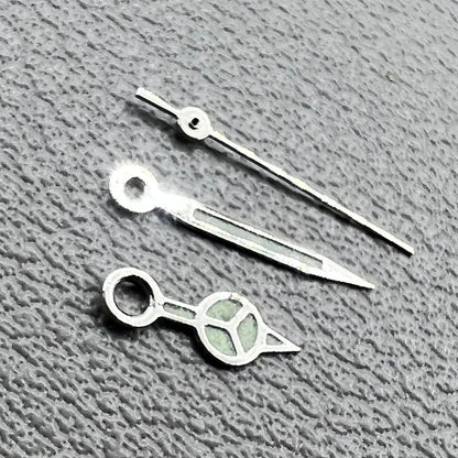 Silver trim green luminous watch hands set for Miyota 1M12 movement, enhancing visibility and style.
