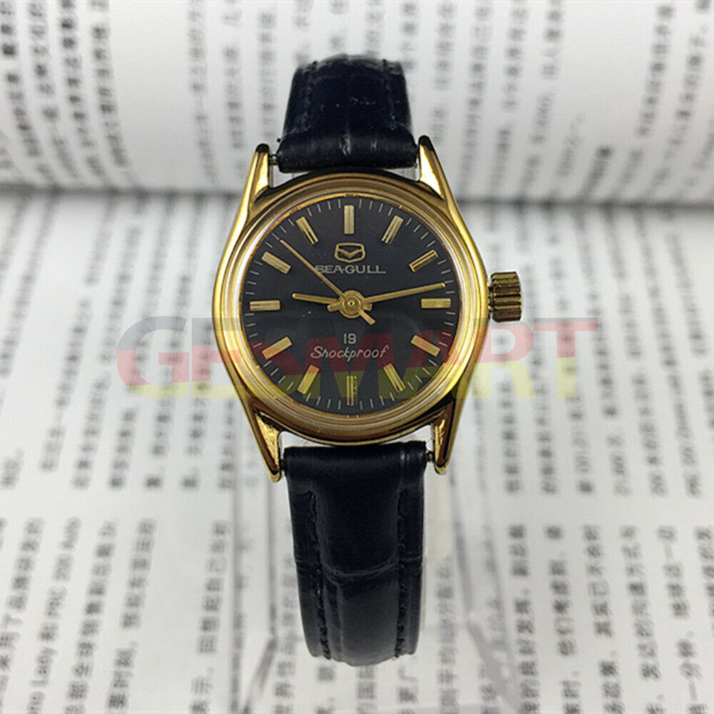 Tianjin Seagull ladies black round watch with gold nail markers and manual mechanical movement, elegant design.