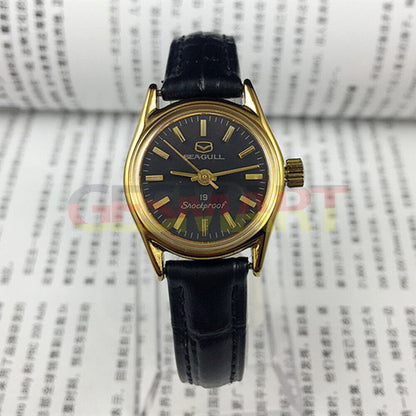 Tianjin Seagull ladies black round watch with gold nail markers and manual mechanical movement, elegant design.