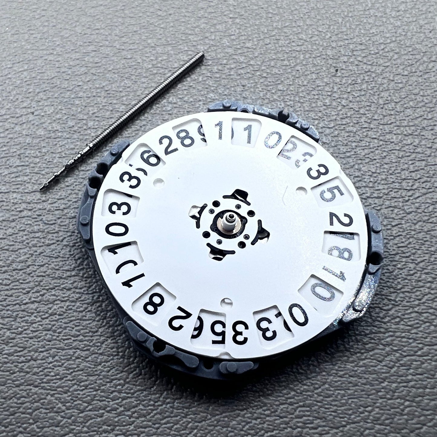 Japan Hattori VJ76B quartz watch movement with date display at 12 o'clock position, precise timekeeping.