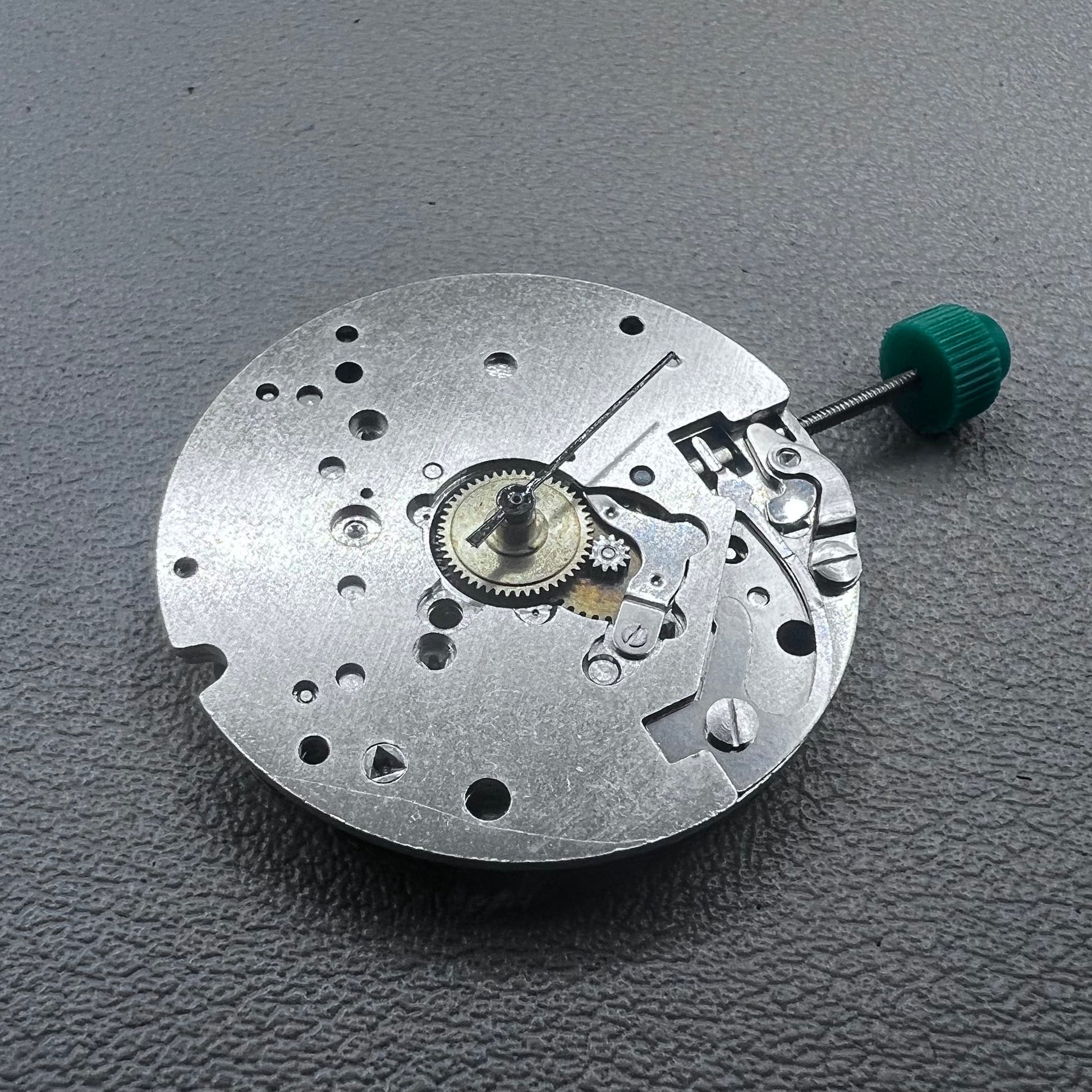 Swiss ETA 6640B quartz watch movement with 3 hands and black circuit board for precise timekeeping.