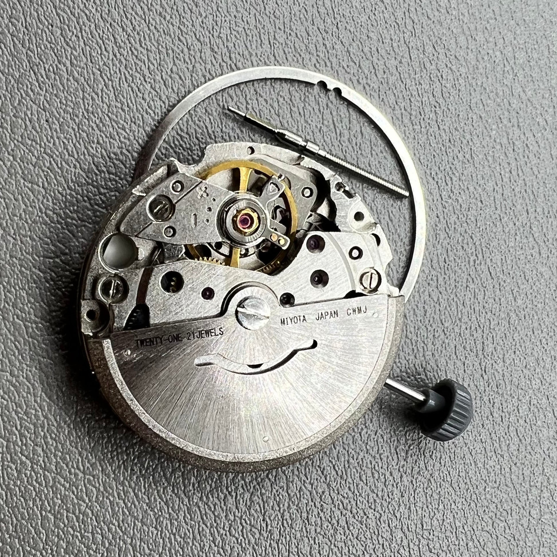 Close-up of Japan Miyota 8200 movement with single date display at 3 o'clock on watch accessory.
