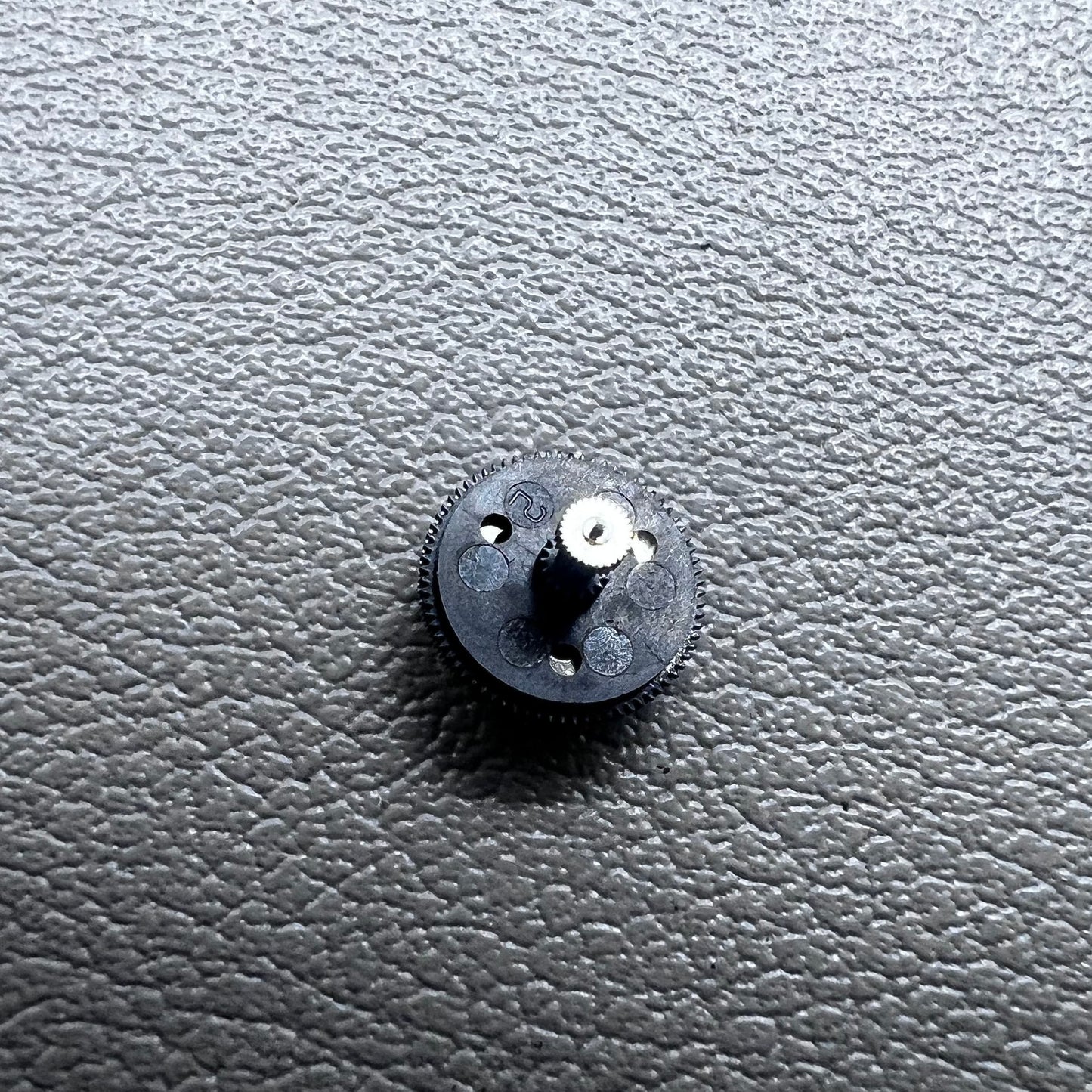 Black counting wheel for ETA C01.211 watch movement, precision replacement part for watch repair.