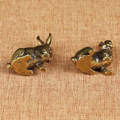 Pair of hand-carved vintage solid copper rabbit figurines for home decor, unique collectible trinkets.