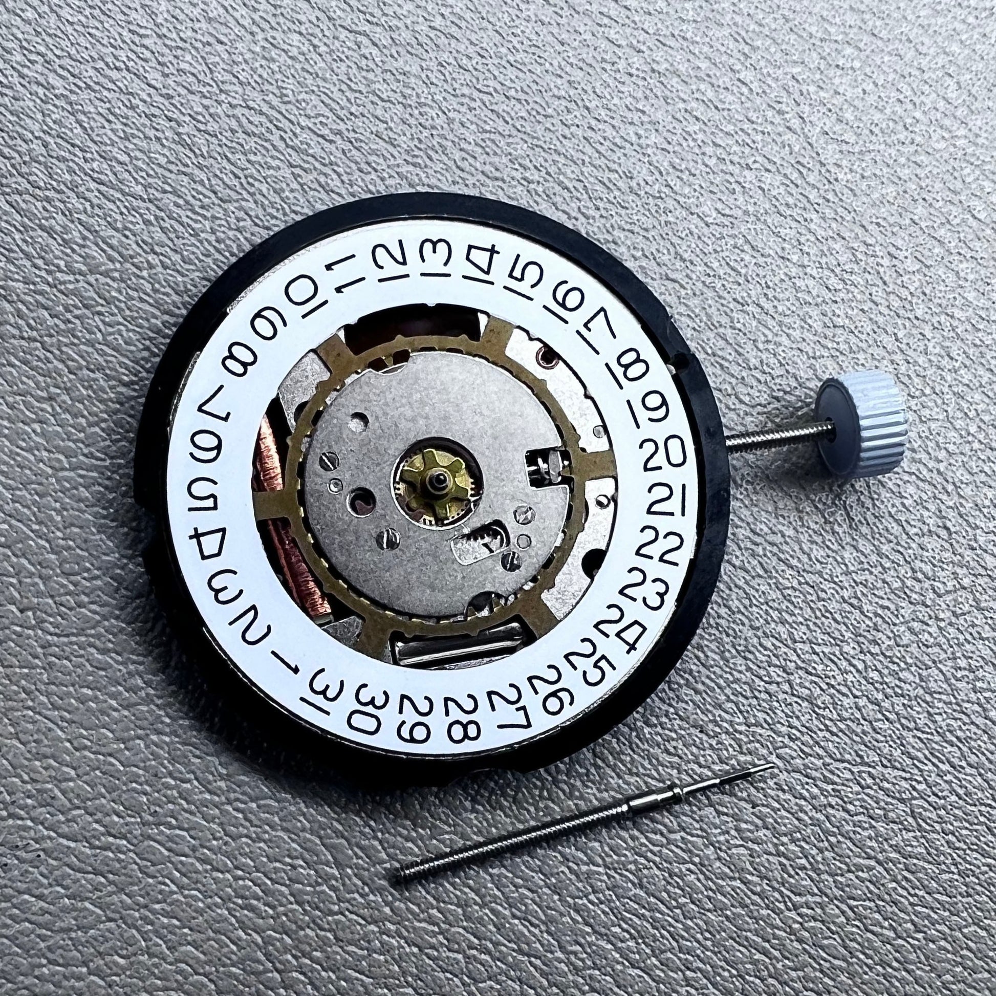 Swiss Ronda 715 quartz watch movement with date display at 3 o'clock, precision timing for accessories.