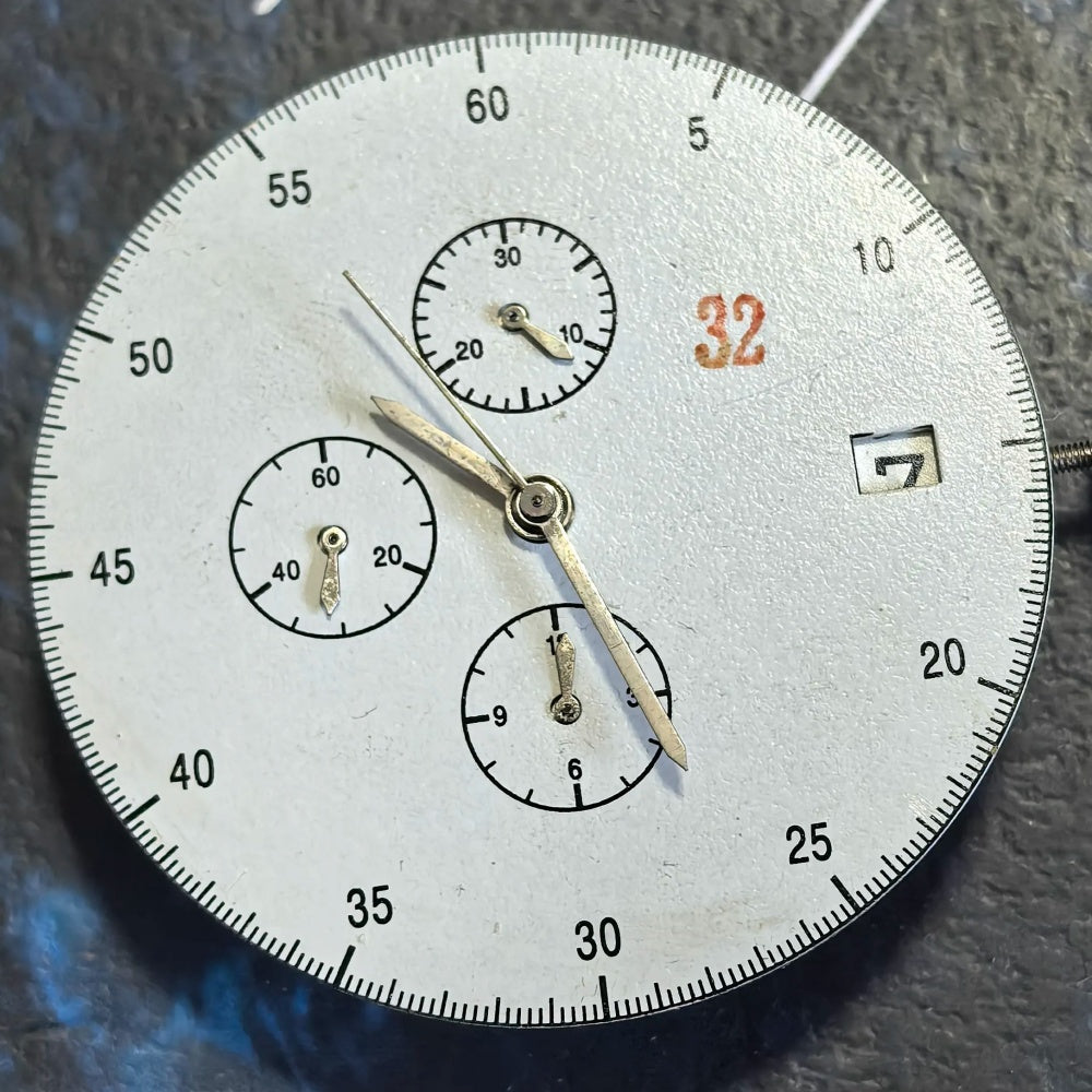 Chinese Dandong 7750 mechanical watch movement showing date at 3 and small seconds at 6, 9, 12 positions.