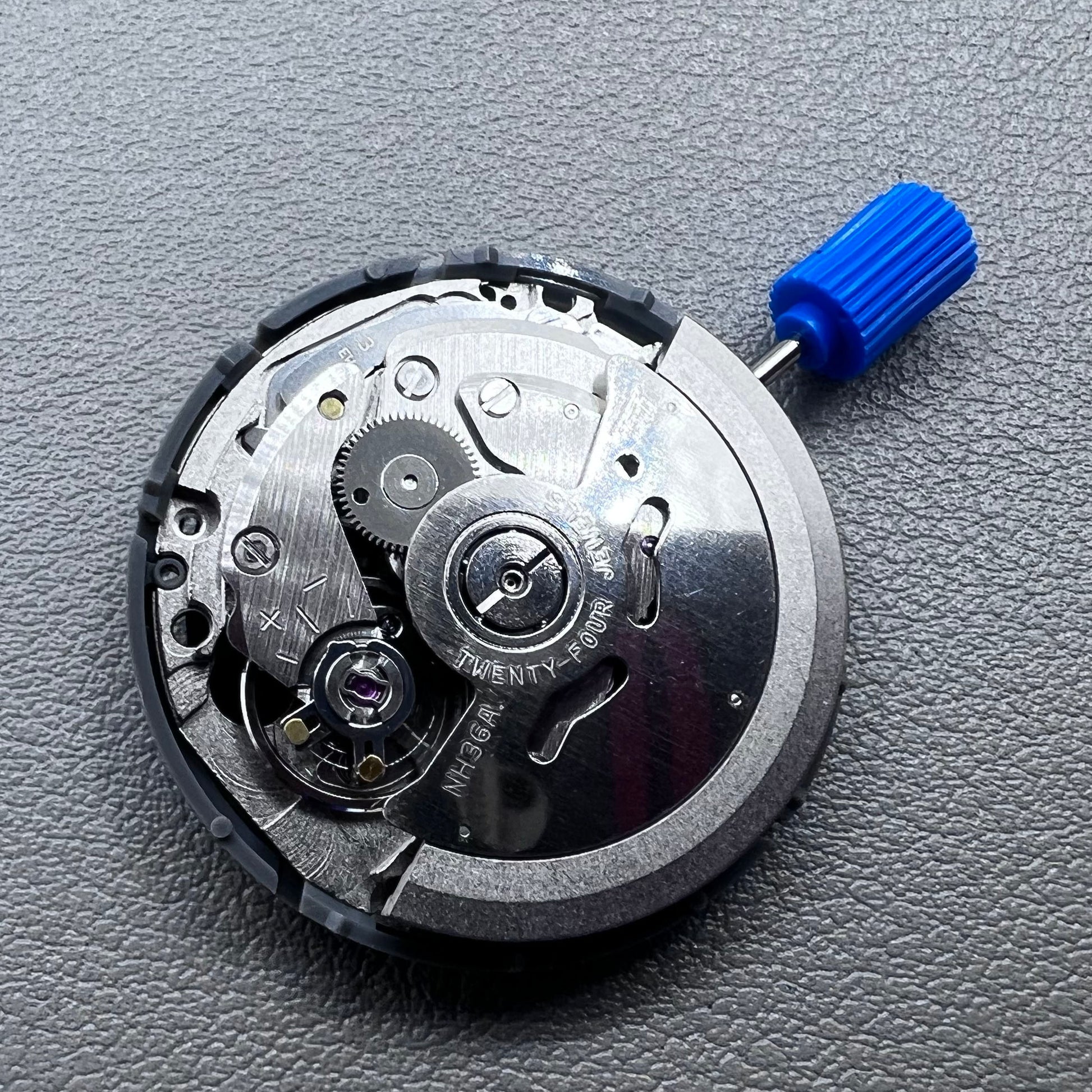 Seiko NH36A automatic movement with black Roman wheel crown, precise watch accessory for mechanical timepieces.