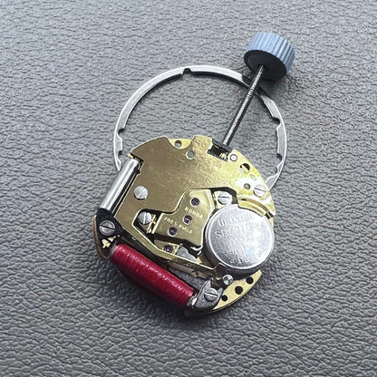 Swiss Ronda 775 quartz watch movement with golden finish, date at 6, and three hands.