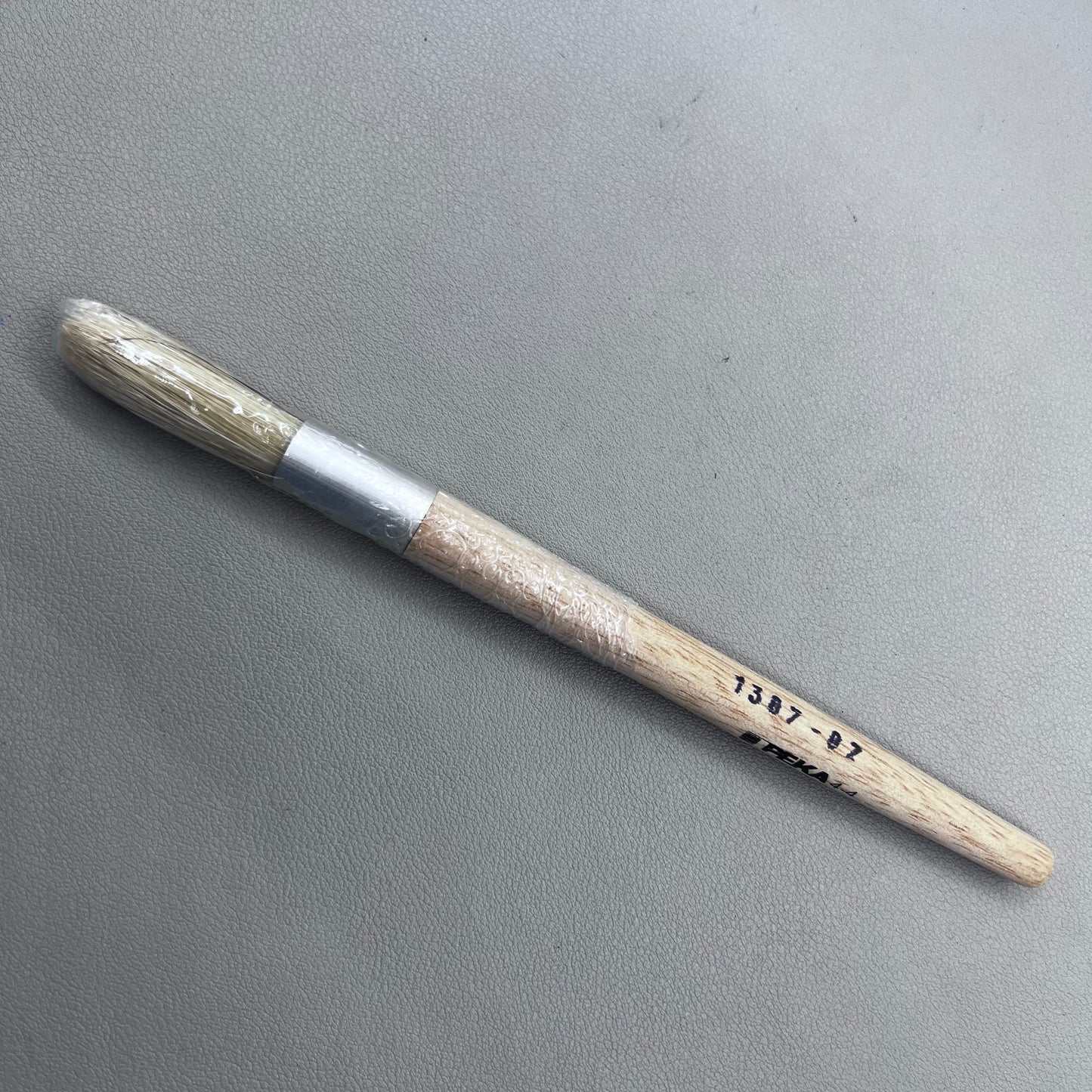 Swiss Bergeon 1307-02 white bristle brush for delicate watch cleaning and maintenance.