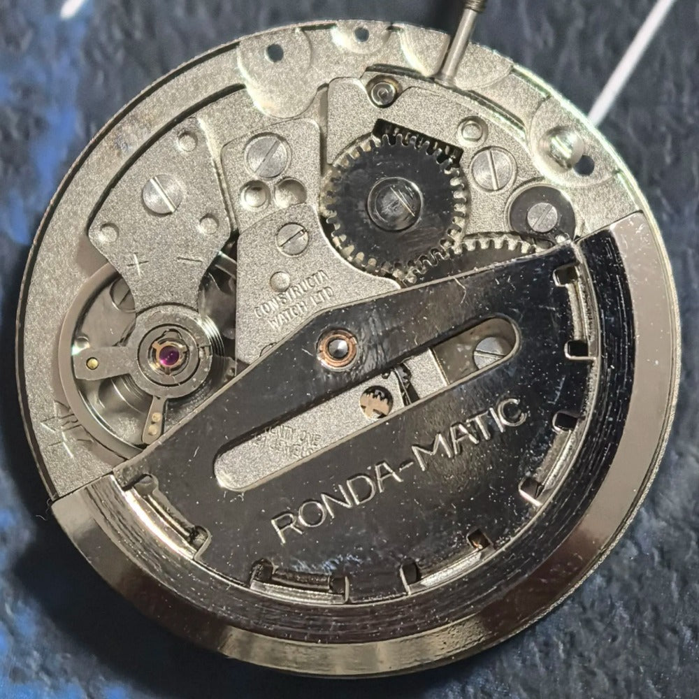 Swiss Made ETA CAL1219 watch movement with double calendar and black font hands for precise timekeeping.