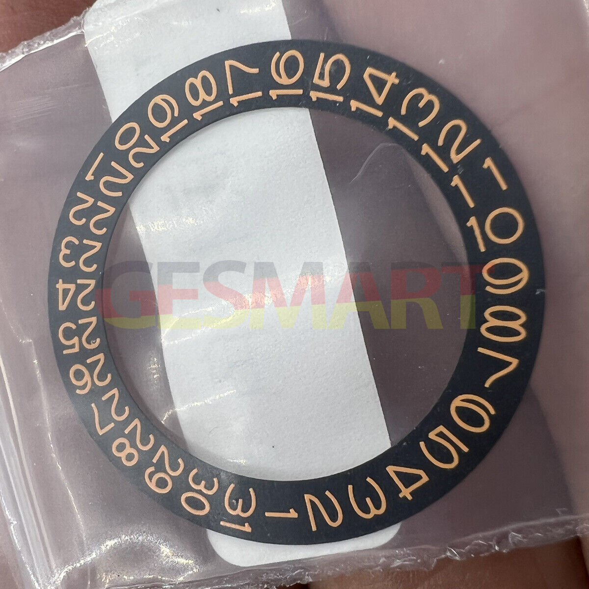 Black background close-up of orange date wheel for Seiko NH35 NH36 watch movement.