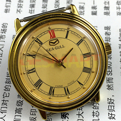 35mm round golden Tianjin Seagull watch featuring manual mechanical movement and refined golden dial.