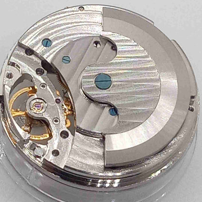 Silver watch accessory with mechanical movement, moonphase at 12, large flywheel detail, China made.