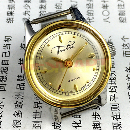 Elegant 26mm Liaocheng TAISHAN lady watch with manual mechanical movement, 19 jewels, and gold-tone detailing.