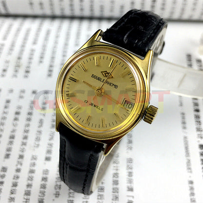 Double Rhomb lady watch with golden dial, manual mechanical movement, and single calendar display.
