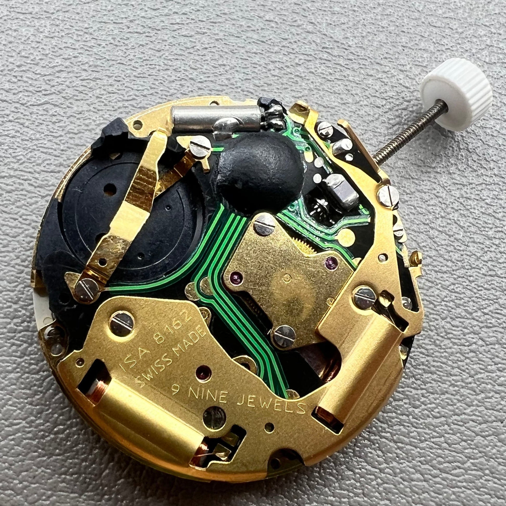 Swiss ISA 8162 golden watch disk with date feature, quartz movement replacement by ISA, ideal for watch repair.